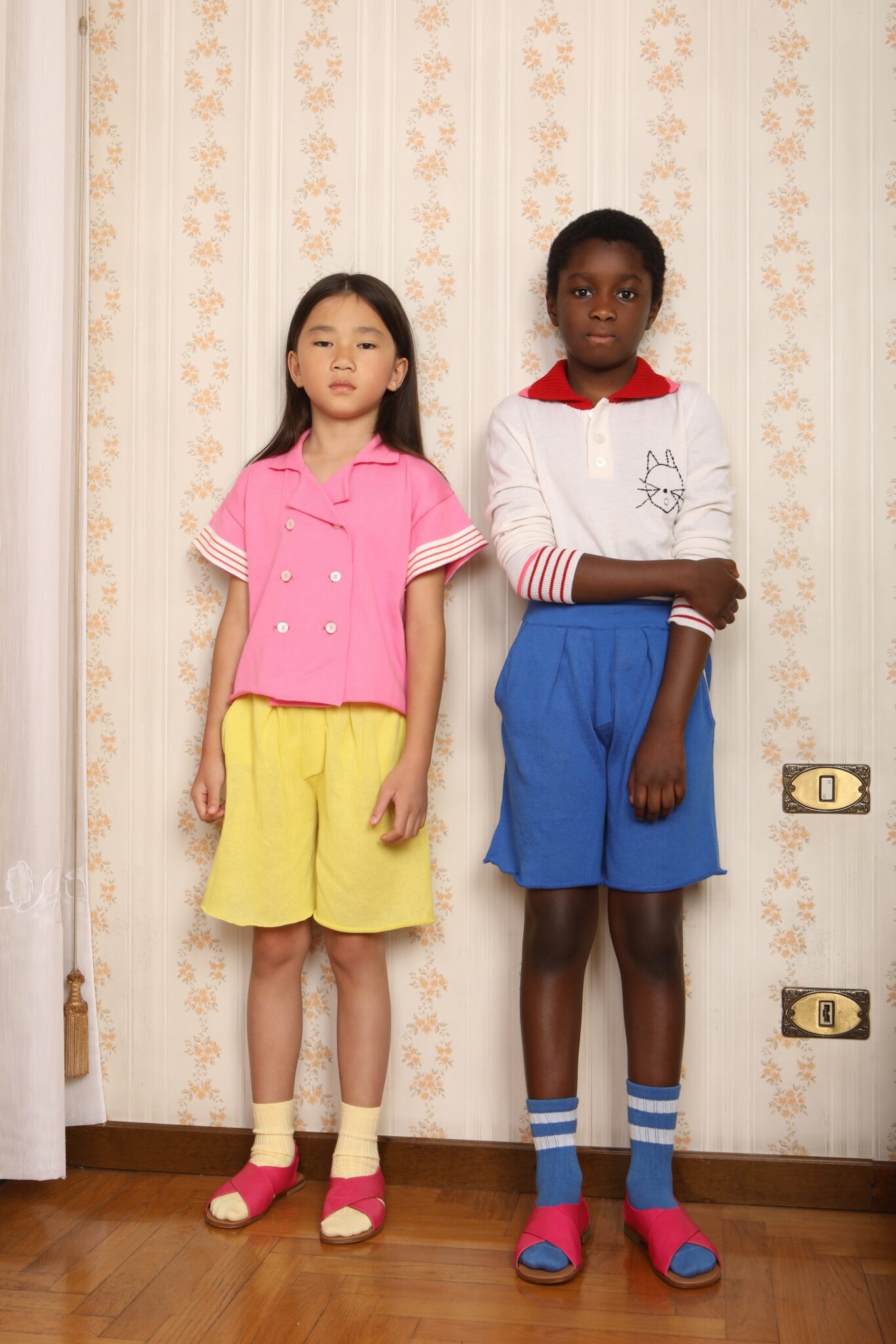 asian girl dressed in yellow pants and pink blouse, black boy dressed in mariniere outfit
