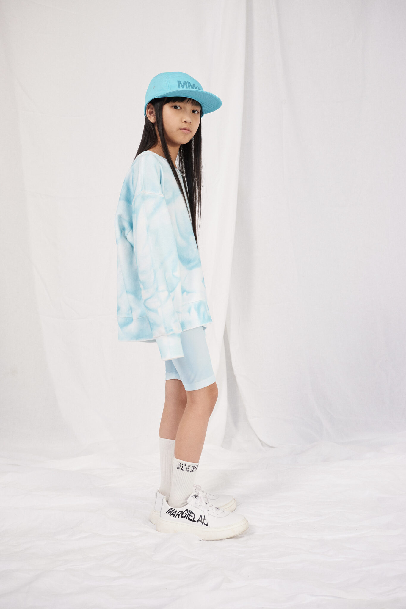 The SS24 collection features a playful palette that delights the eye while remaining functional for children's everyday wear. Expect to see a mix of bold colors and muted tones, carefully curated to allow young personalities to shine. The fabrics chosen for this collection are a testament to MM6's dedication to unexpected combinations—think lightweight materials paired with robust textures, creating a tactile experience that is both unique and comfortable.
