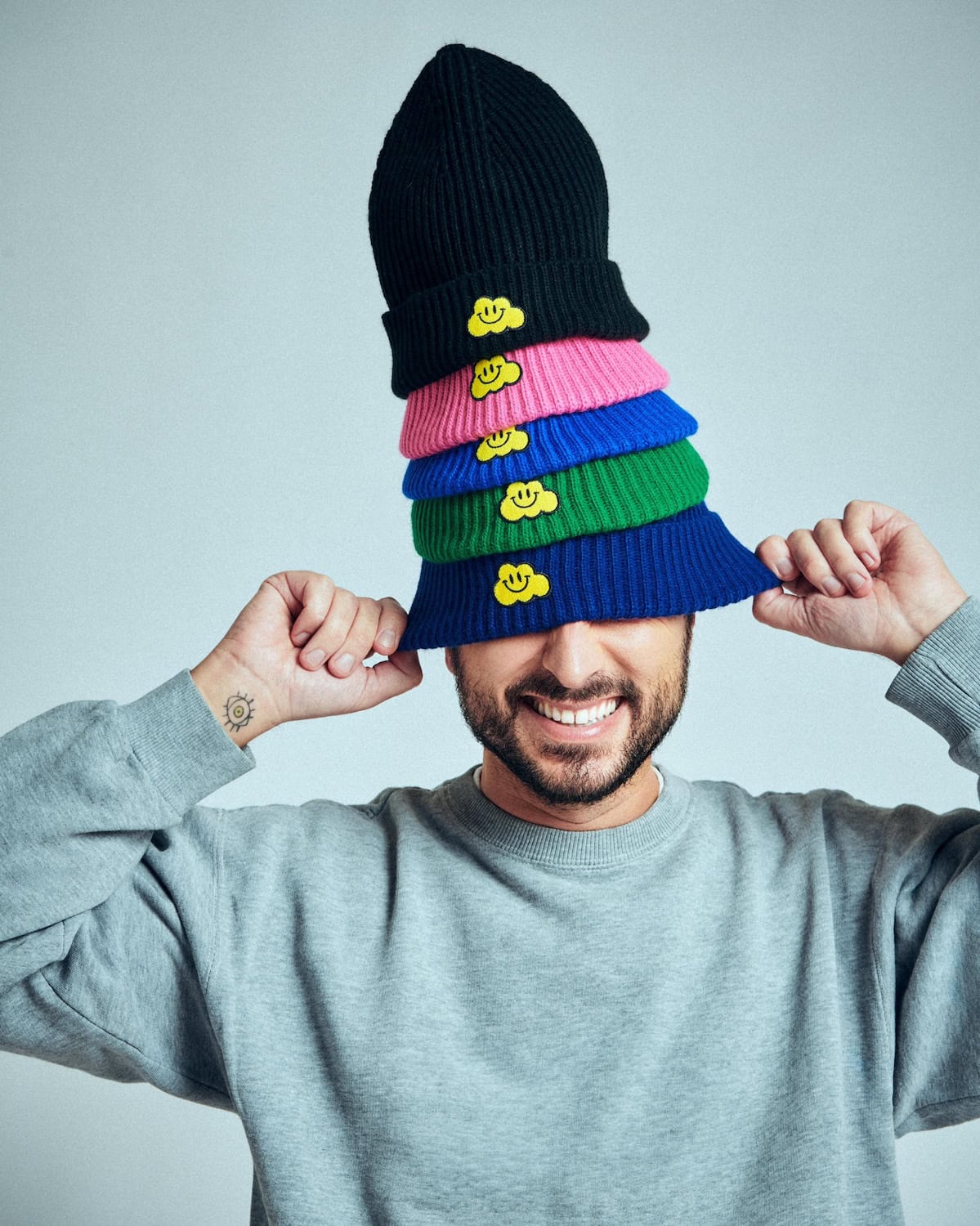 What a playful and vibrant image showcasing Cesare Morisco's new beanie collection! The bright, stacked colors and the cheerful smiley details give these beanies a fun, cheerful look that kids and adults alike will adore. Each color seems carefully chosen to add a pop of personality, making this collection perfect for adding a touch of whimsy to any outfit. Would you like help with a caption or specific details for this collection?