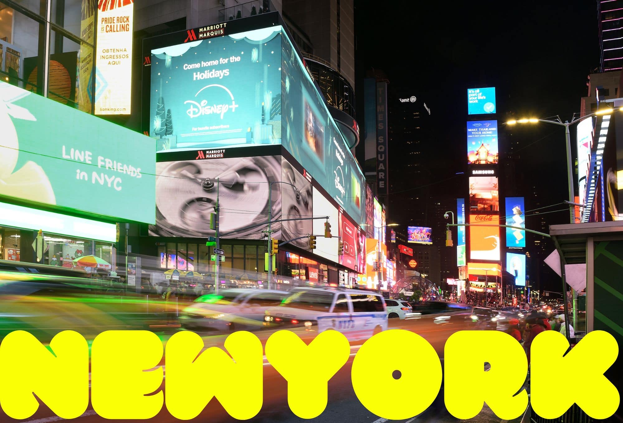 A vibrant nighttime view of Times Square in New York City, filled with colorful illuminated billboards and advertisements, including one for Disney+ with a holiday theme. The streets are bustling with motion-blurred yellow taxis and cars, while