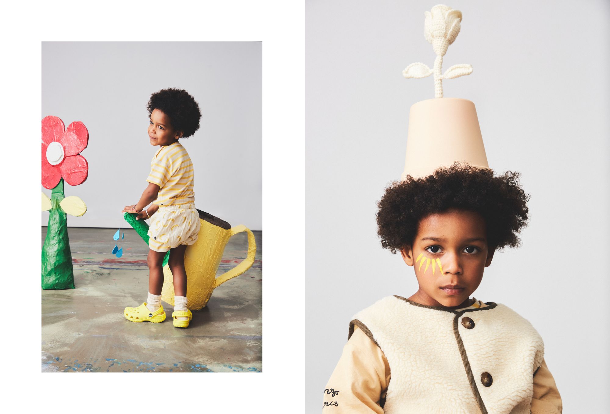 Children’s fashion editorial with a playful botanical theme. On the left, a young child in a yellow striped T-shirt, cream-colored shorts with yellow patterns, and bright yellow clogs stands atop a giant paper-mâché watering can, smiling at the camera. Colorful paper flowers and water droplets complete the whimsical garden scene. On the right, a close-up portrait of the same child shows them wearing a soft beige and cream sherpa vest over a tan shirt, with yellow petal shapes painted on their cheek. A flower pot with a crocheted white bloom is balanced on their head like a hat, blending fantasy and fashion.