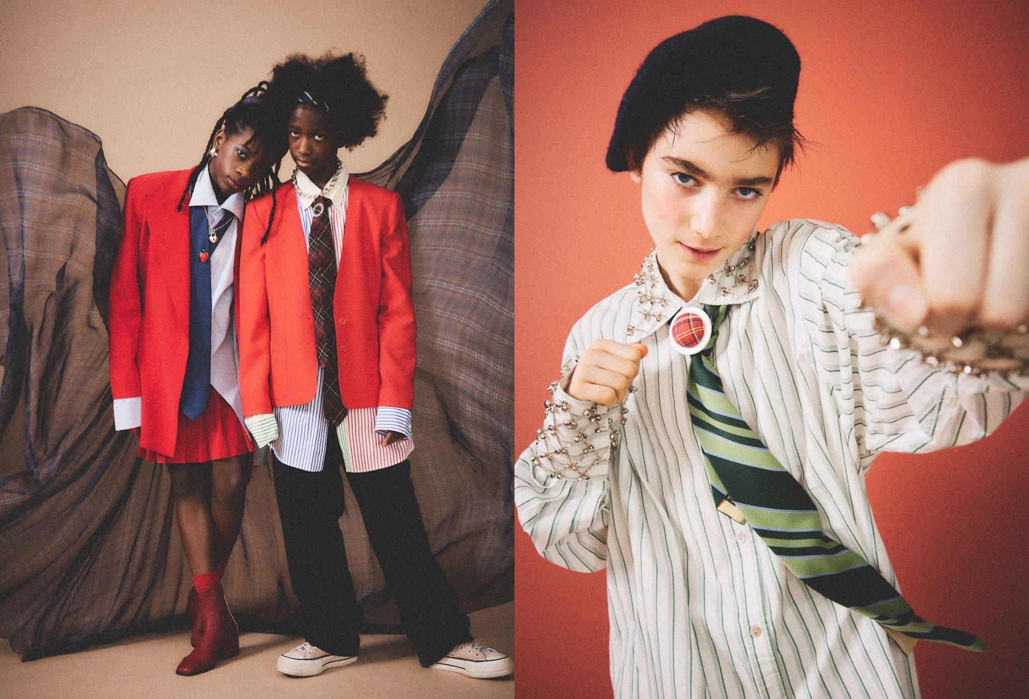 Fashion editorial by Molly Magnuson showcasing bold, youthful styling with a rebellious edge. On the left, two young models stand against a backdrop of flowing plaid fabric, both wearing oversized red blazers layered over mismatched shirts and ties. One model wears a pleated red skirt and ankle boots, while the other pairs wide pants with sneakers. On the right, a close-up of a third model features a playful pose with a clenched fist toward the camera. The model wears a green-striped oversized shirt adorned with silver embellishments, a green tie, and a plaid brooch at the collar, topped with a black beret. The setting mixes punk, prep, and play.