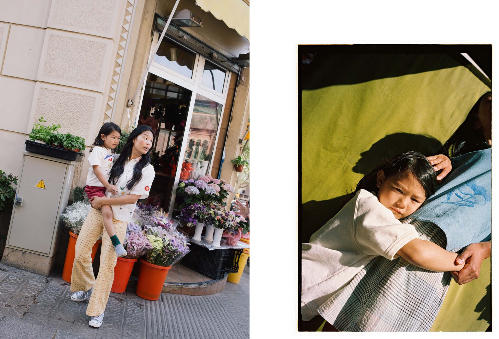 Two photographs by Paola Amenta. On the left, a woman stands outside a flower shop holding a young girl in her arms, both looking to the side with a sense of alertness or curiosity; vibrant bouquets surround them. On the right, the same child lies in the woman's lap, bathed in warm sunlight, resting against her mother’s body with an expression of quiet intensity, evoking tenderness and protection.