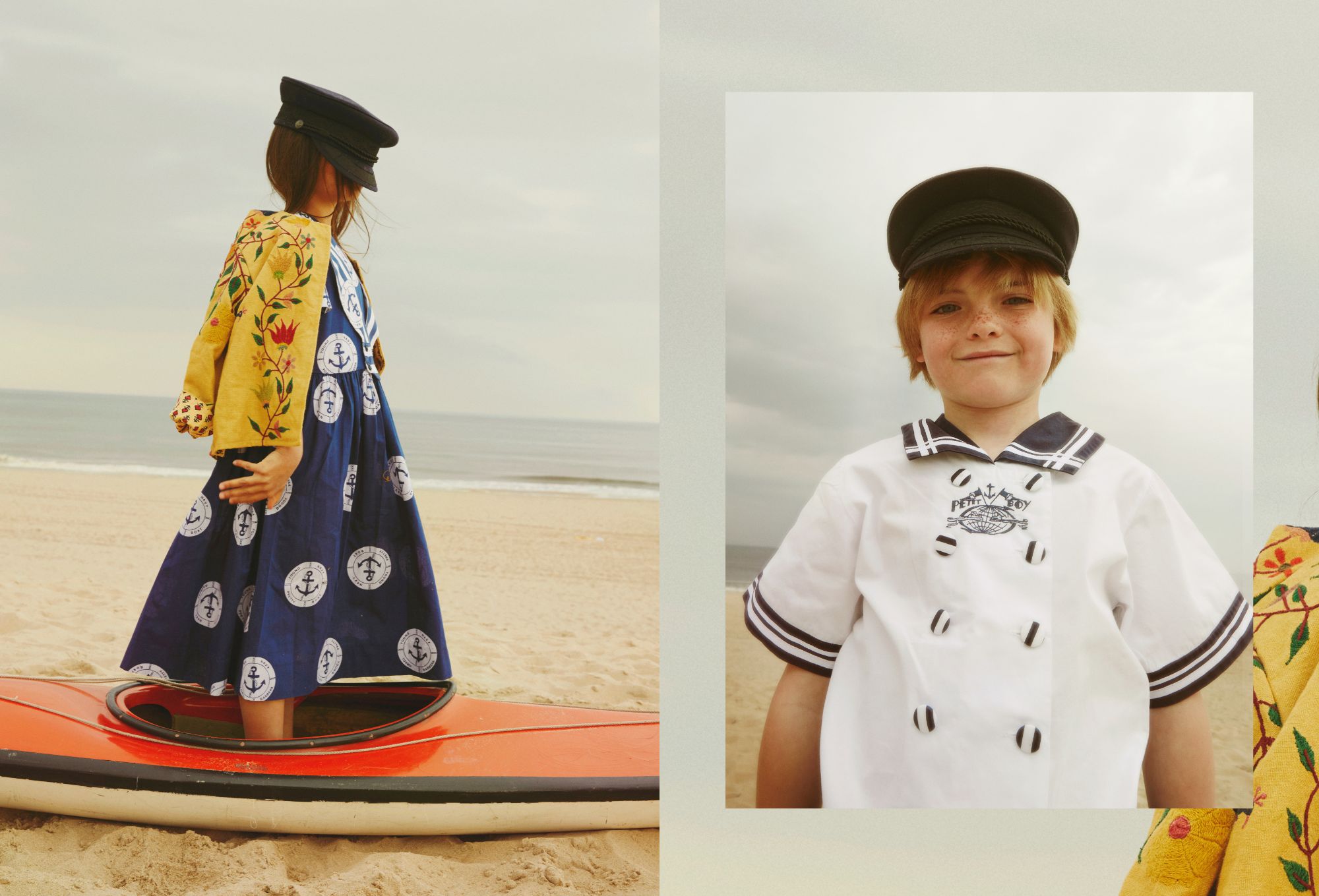 Left: A child stands in a red kayak on the beach, wearing a navy dress with anchor prints, a yellow embroidered jacket draped over the shoulders, and a black sailor-style cap. Right: A smiling boy with freckles wears a white sailor shirt with navy details and a matching cap, posing in front of a cloudy sky at the beach.