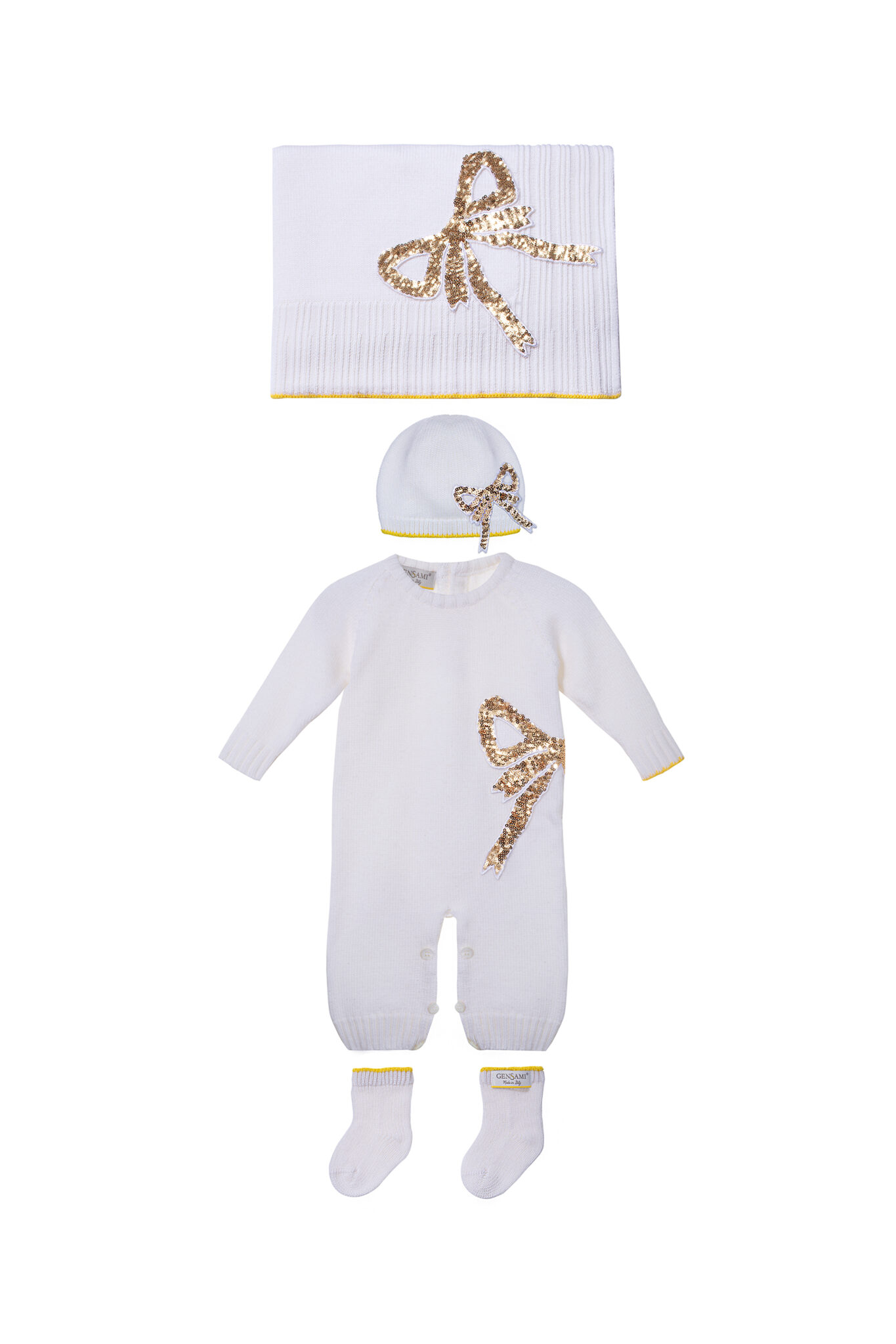 White baby set with sequin bow motif including blanket, romper, hat, and socks from Gensami FW25.