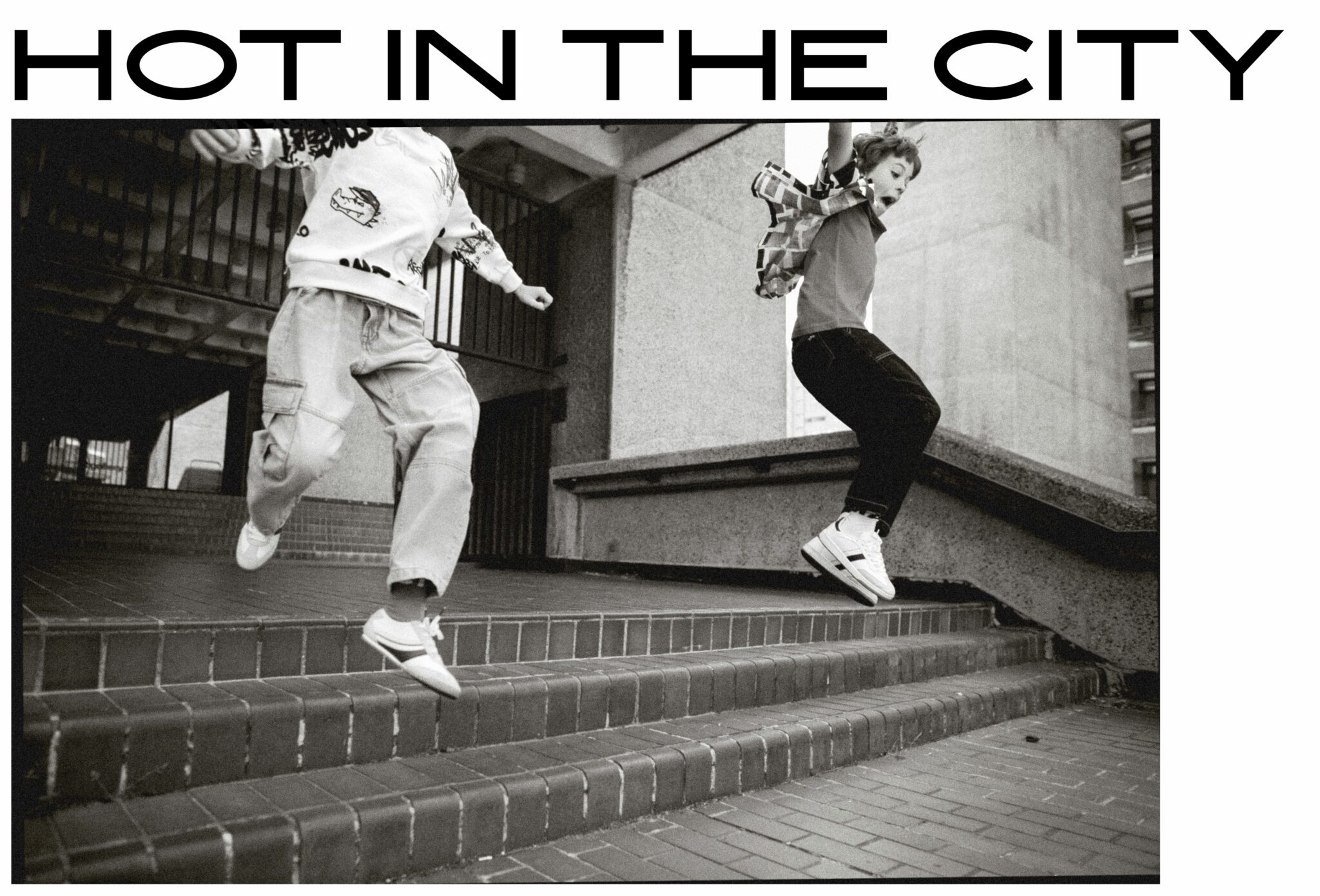 Kids fashion editorial 'Hot in the City' by Hannah Mentz, SS25 streetstyle and skater looks, shot in the UK for Scimparello Magazine. Gene in SS25 jeans, sweatshirt, and trainers by Zara Kids with Main Story socks; Sebastian in SS25 jeans by The New Society, Main Story socks, Wynken shirt, and red H&M T-shirt.