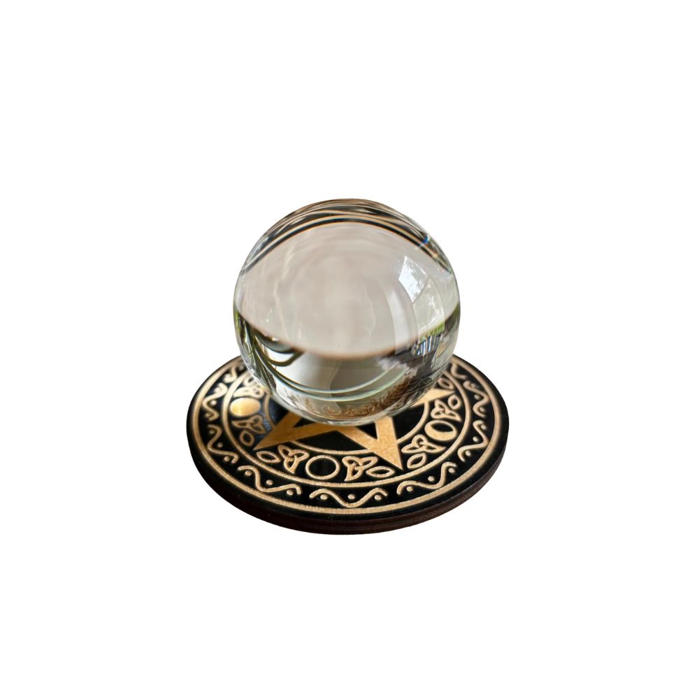 Decorative crystal ball on engraved wooden base, featured in the Mystical Gypsy Halloween styling by Scimparello Magazine.