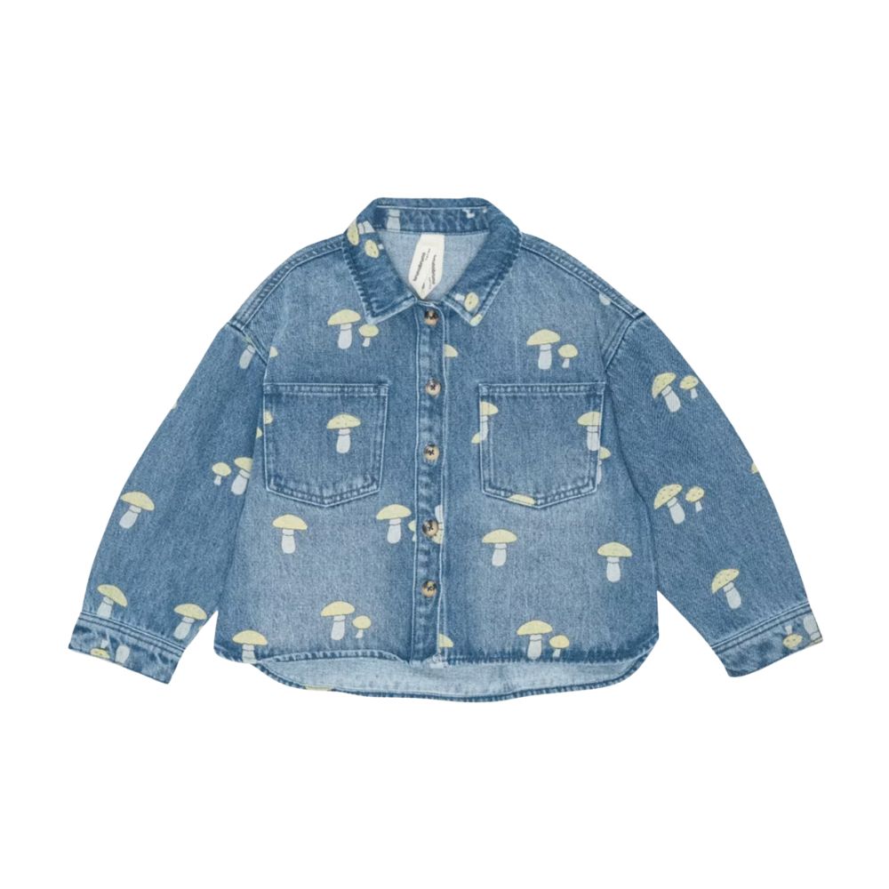 Denim shirt by BRUNObruno nation with an all-over mushroom print, featured on Scimparello Magazine. A playful twist on a classic kidswear piece with soft washed denim.