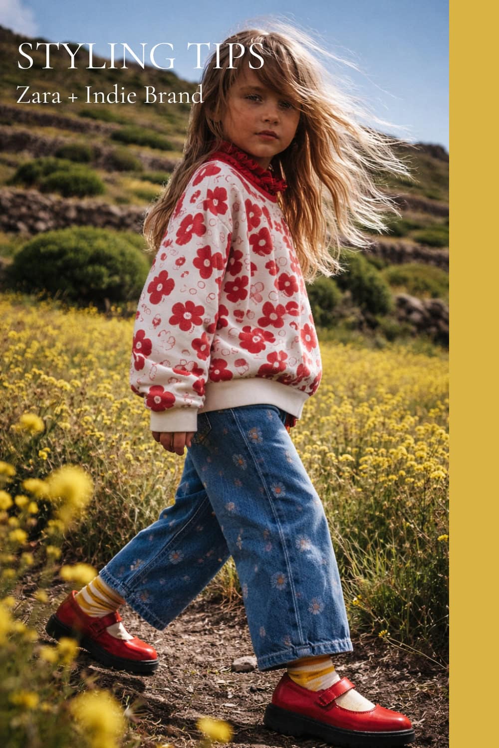 Girl walking through a yellow wildflower field wearing a red floral sweatshirt by LOUD, wide-leg blue jeans with small daisy print from Zara, yellow striped Collégien socks and red Mary Jane shoes by Pèpè Children, styled for a Zara + independent brand mix, featured in Scimparello Magazine Styling Tips.