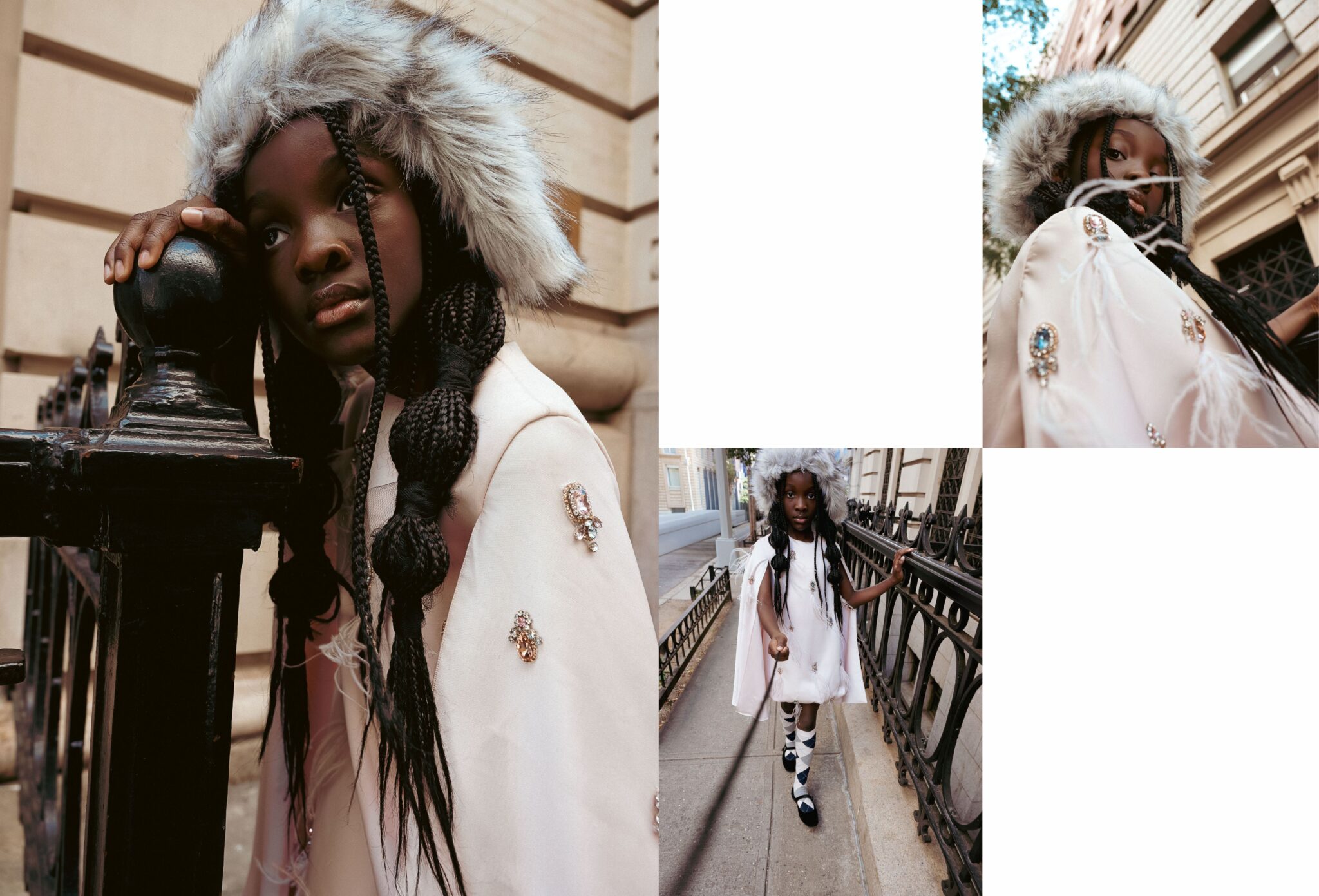 Kids fashion editorial The City Above Us for Scimparello Magazine. Black girl with long braids wearing a white embellished cape and fur hat walking along a New York street with iron railings and classic city architecture. Photo by Ilaria and Silvia Cianciaruso.