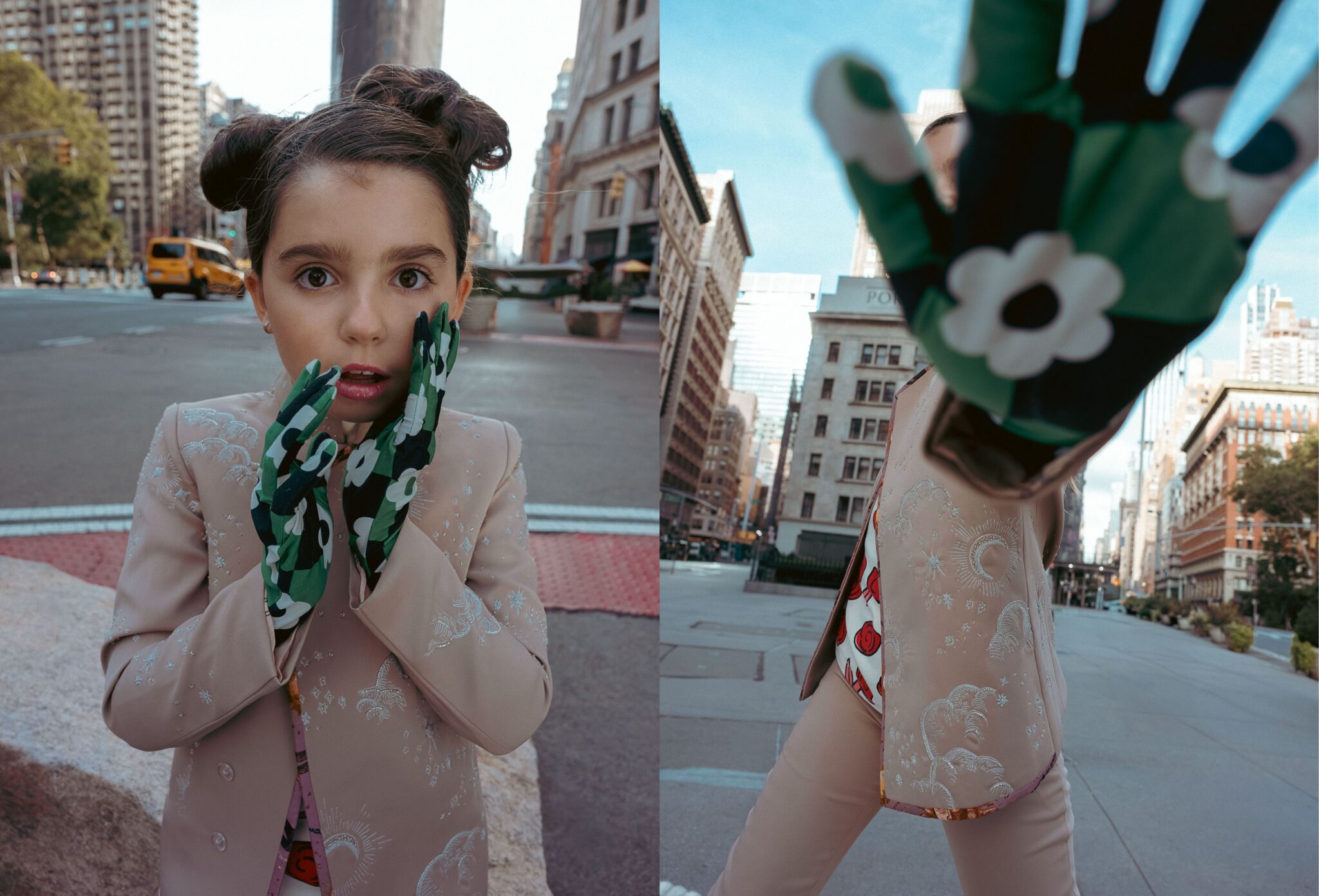 Kids fashion editorial The City Above Us for Scimparello Magazine. Girl with hair in two buns wearing a pale embroidered jacket and green floral gloves standing in the middle of a New York avenue with city buildings and yellow taxis in the background; paired with a playful perspective shot as she reaches toward the camera. Photo by Ilaria and Silvia Cianciaruso.