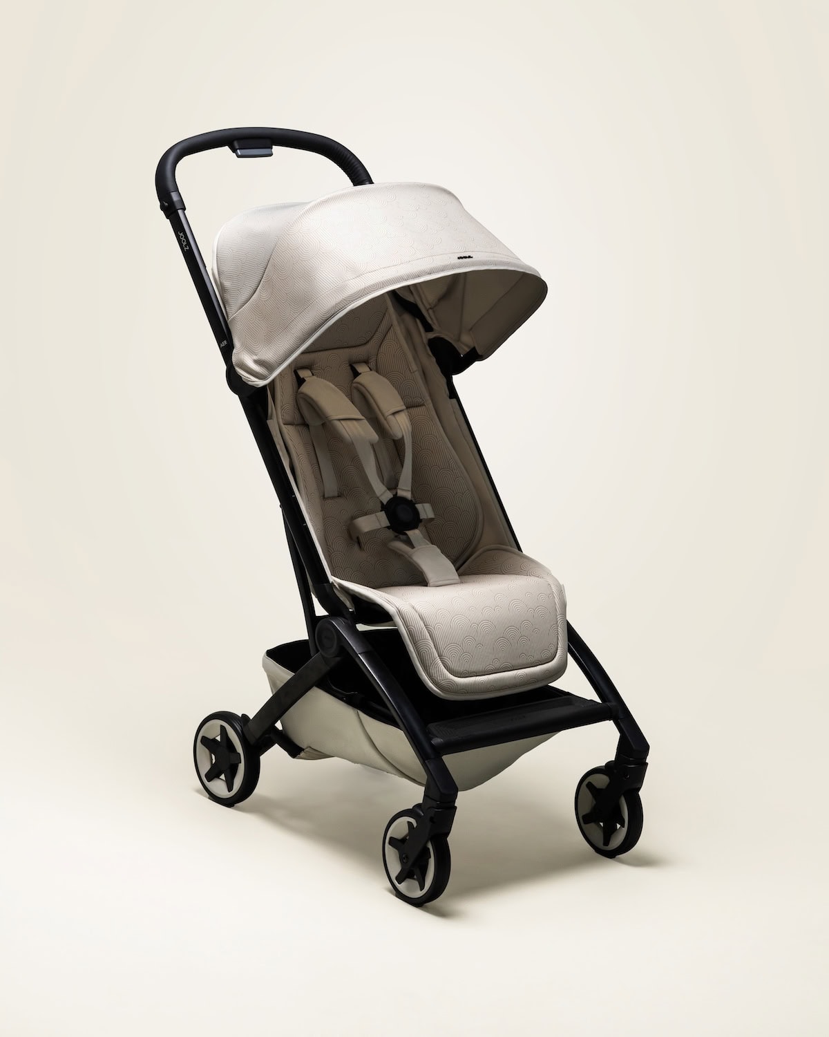 Joolz Aer2 Limited Edition Calming Beige ultra-compact stroller with minimalist design, ergonomic seat and beige canopy, isolated on neutral background.
