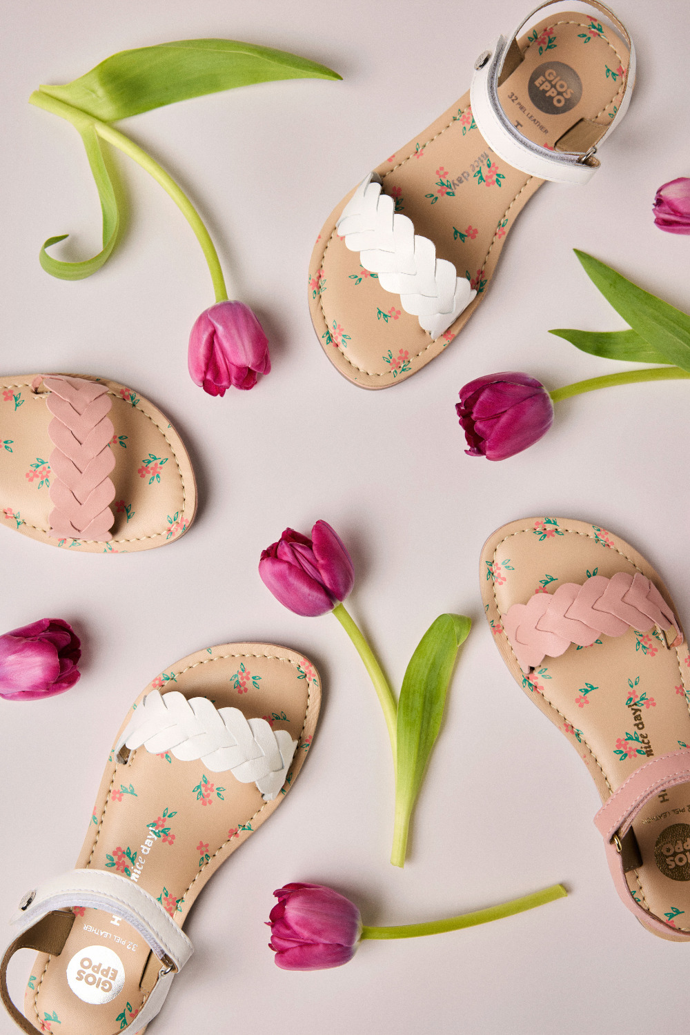 Flat lay of Gioseppo Kids SS26 floral sandals with braided straps and pink tulips, featured in the Freedom to Celebrate collection for Scimparello Magazine.