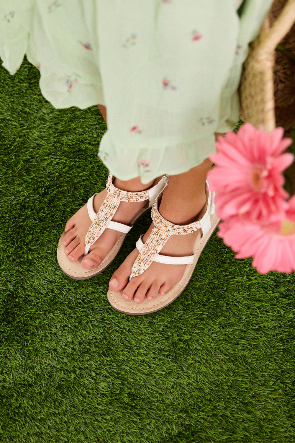 Close-up of white beaded Gioseppo Kids SS26 sandals worn with a pale green floral dress, featured in the Freedom to Celebrate collection for Scimparello Magazine.