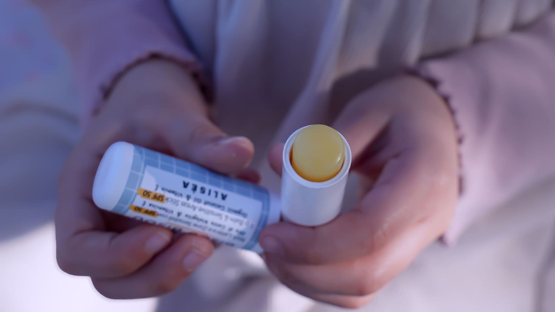 Alisea Bisou Bisou SPF50 stick for babies held in hands, showing the protective balm for sensitive face areas, featured on Scimparello Magazine