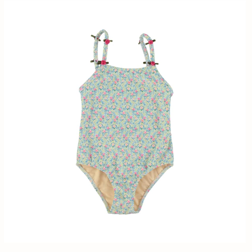 Blue floral bathing suit with small pink flowers, shoulder straps and rose details, styled for a Shop Floral Skirts selection by Scimparello Magazine.
