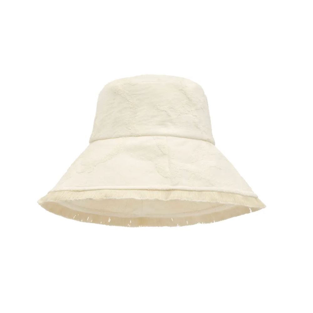 White textured bucket hat with wide brim, styled for a Shop Floral Skirts selection by Scimparello Magazine.