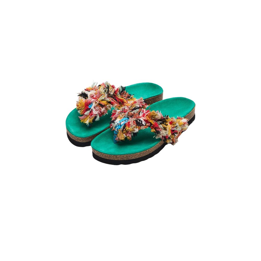 Turquoise Maison Mangostan flip-flops with colorful fringed straps, styled for a Shop Floral Skirts selection by Scimparello Magazine.