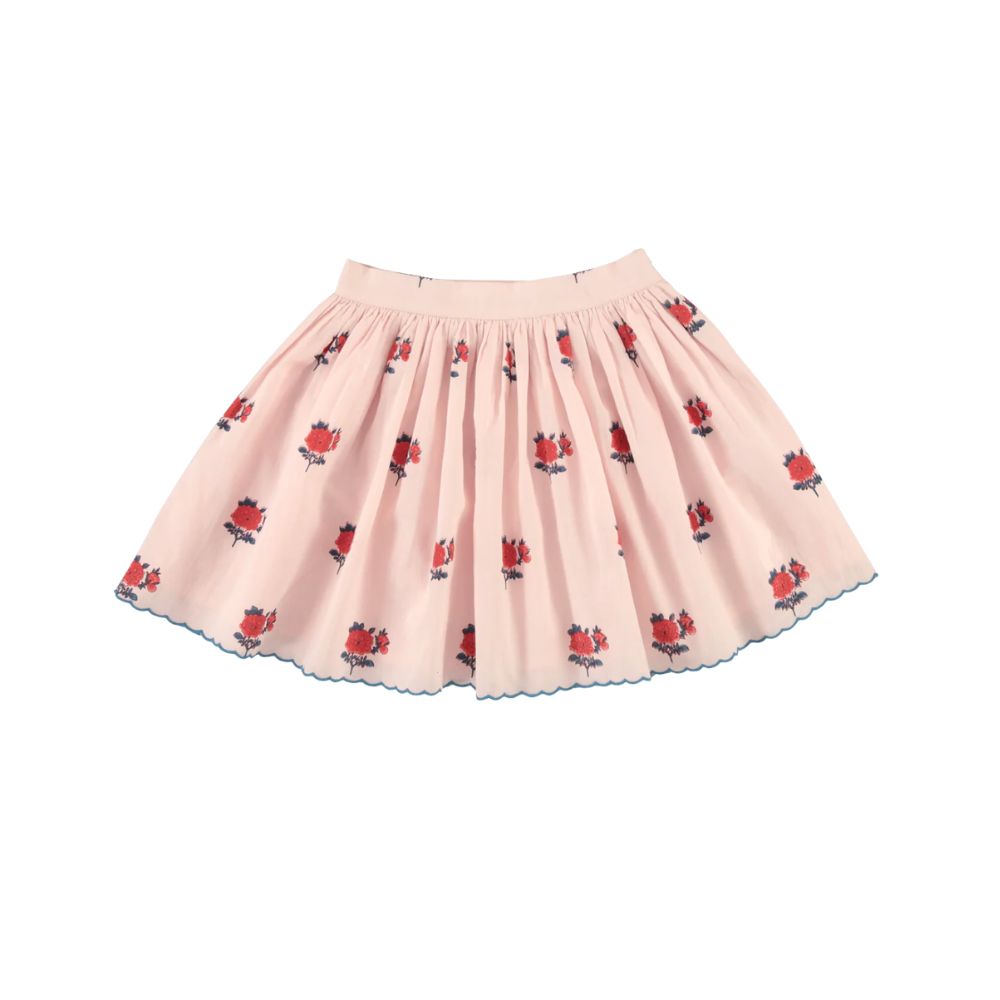 Pink Bebe Organic floral skirt with embroidered red flowers and scalloped hem on a white background, featured in Scimparello Magazine’s shop floral skirts selection.