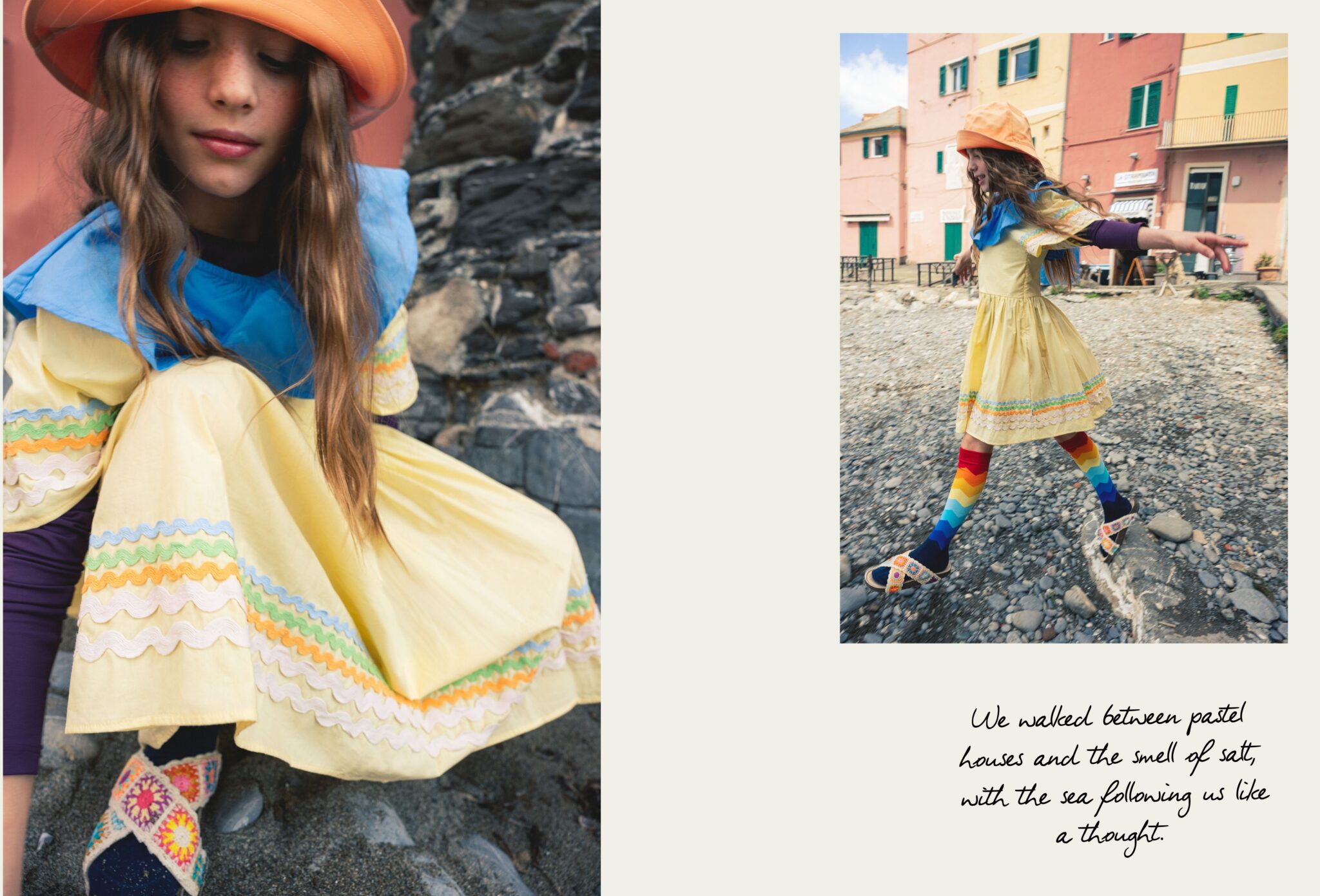 Girl in a yellow summer dress, orange bucket hat and rainbow socks walking across the pebbled beach in Boccadasse, Liguria, with pastel houses in the background, photographed by Ilaria & Silvia Cianciaruso for Scimparello Magazine.