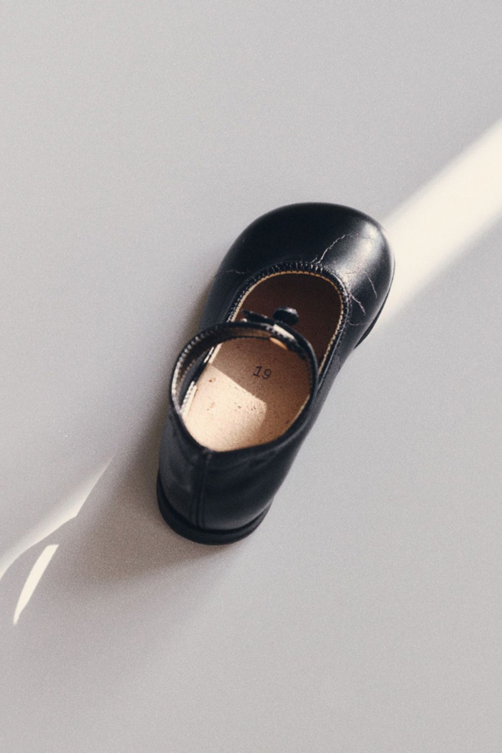 Close-up of a classic black Bundgaard children's leather shoe, showcasing the timeless craftsmanship and heritage behind the Bundgaard Generations collection.