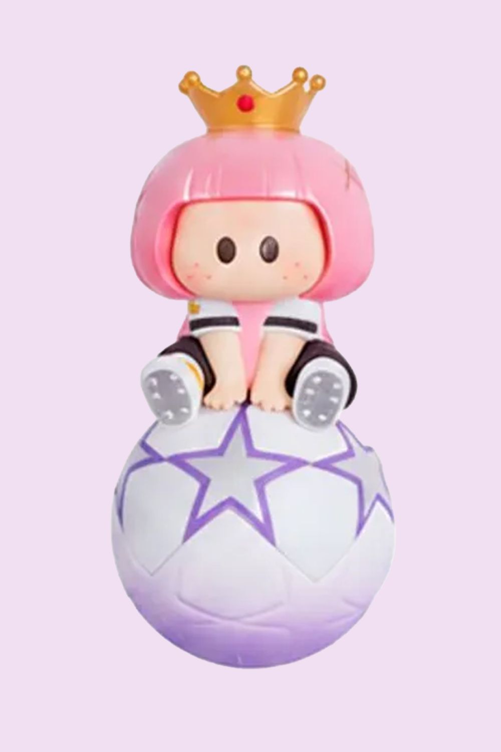 MINISO YOYO Sure Win collectible surprise figure with pink hair and a golden crown, sitting on a football decorated with purple stars against a pastel background.