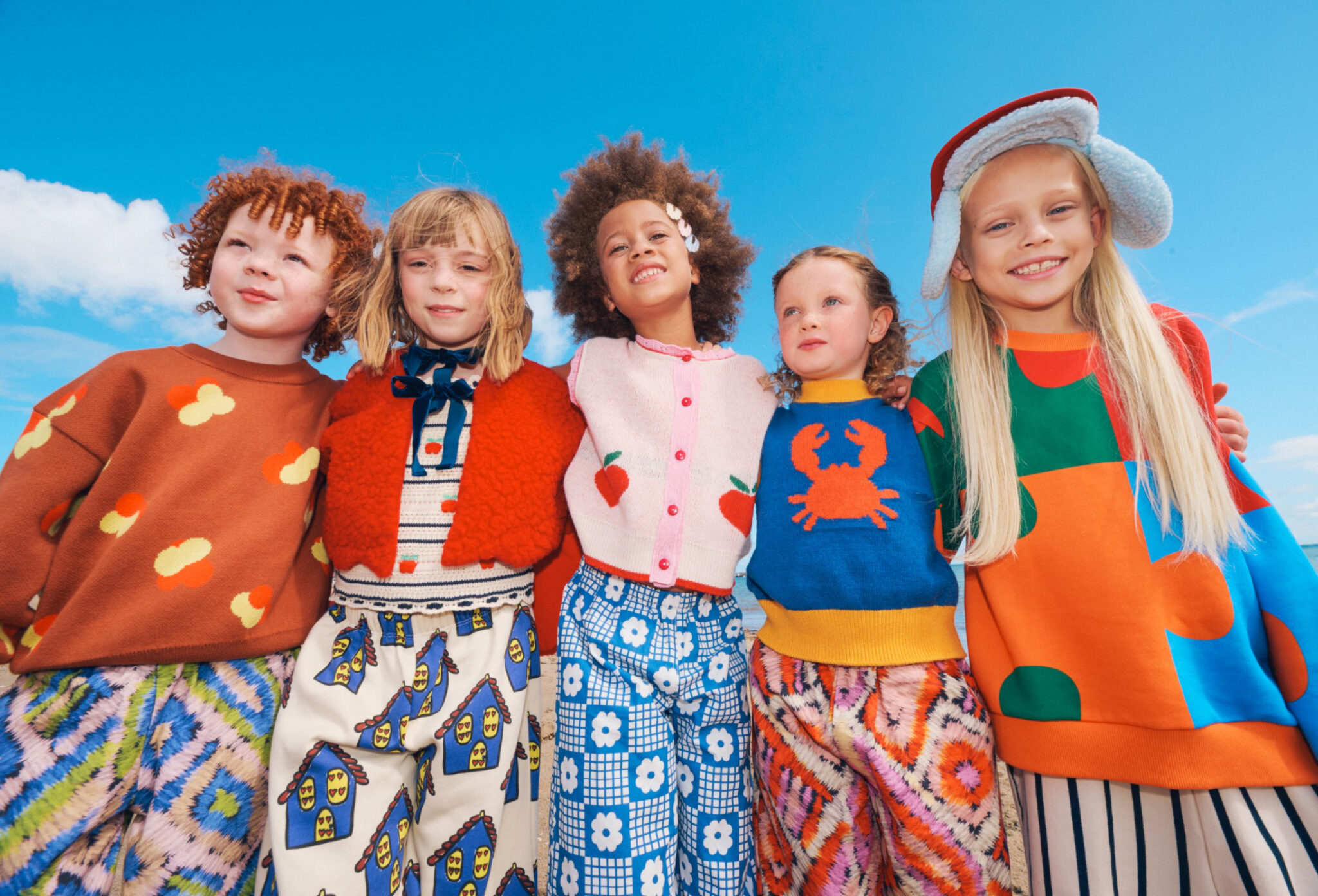 Forecast: Colour FW26 fashion editorial photographed by Alma Rosaz, featuring children in bright colourful kids fashion looks under a vivid blue sky for Scimparello Magazine.