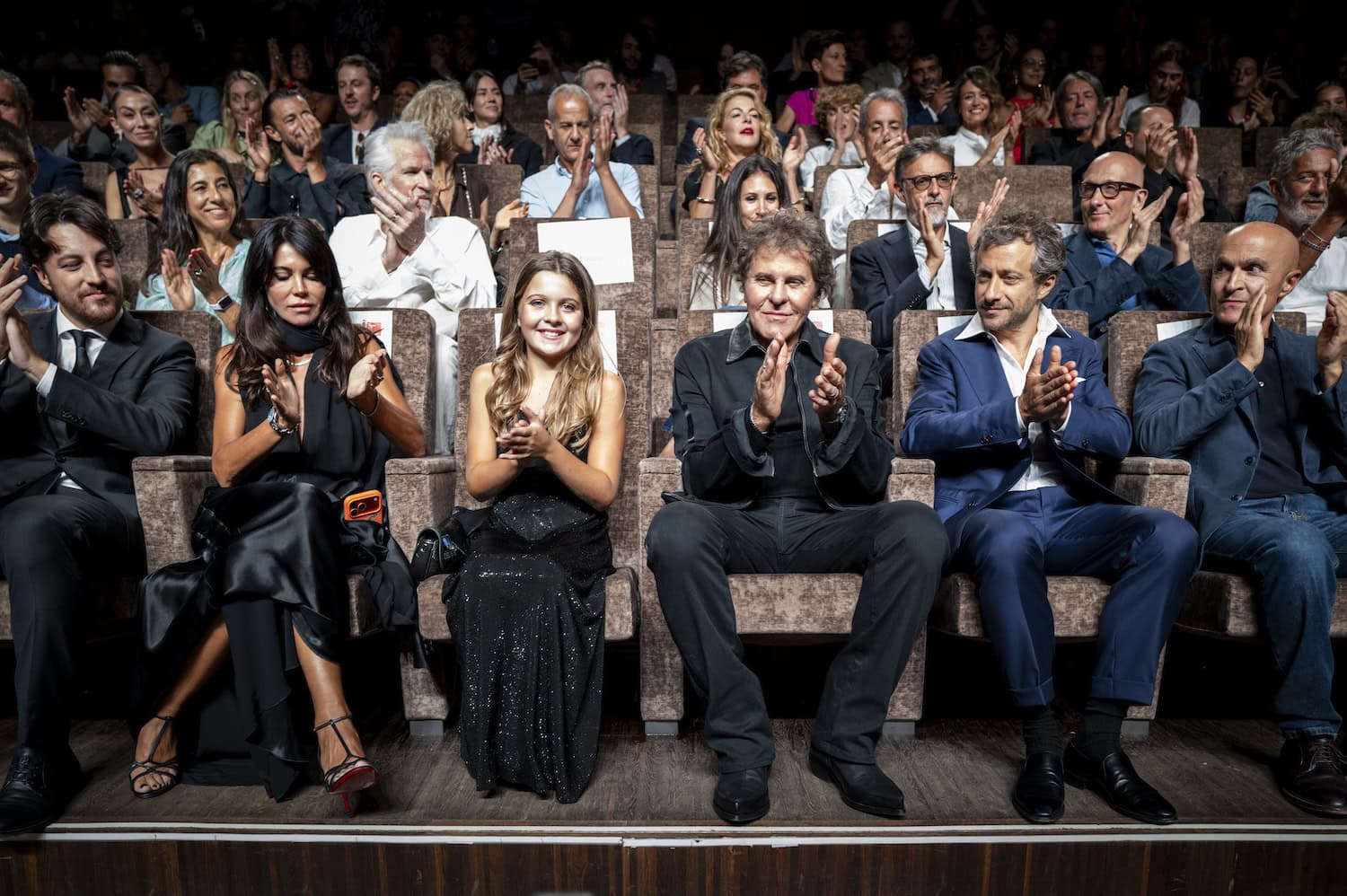 Guests applauding during the premiere of Be Brave, the documentary about Renzo Rosso, at the Venice Film Festival.