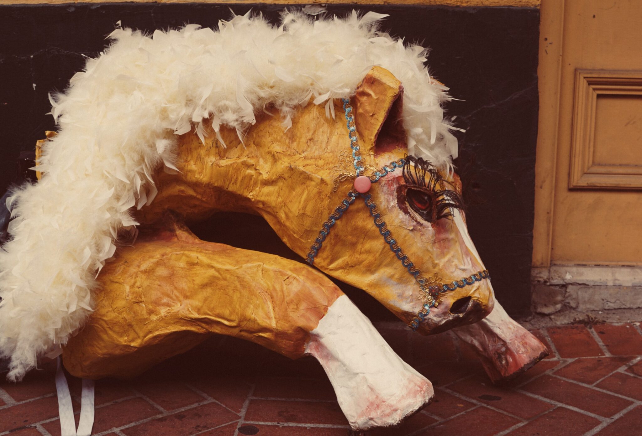 An Afternoon in New Orleans fashion editorial by Dope Style Kid x Jennifer Grasso, featuring a decorative carnival horse prop photographed against warm New Orleans architecture for Scimparello Magazine.