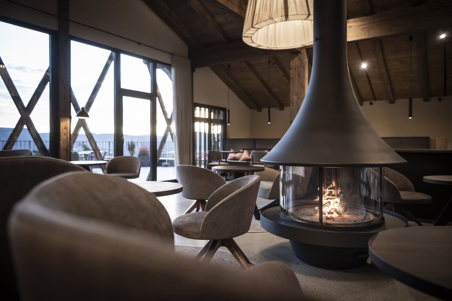 Hotel Gfell lounge with fireplace and mountain view in South Tyrol