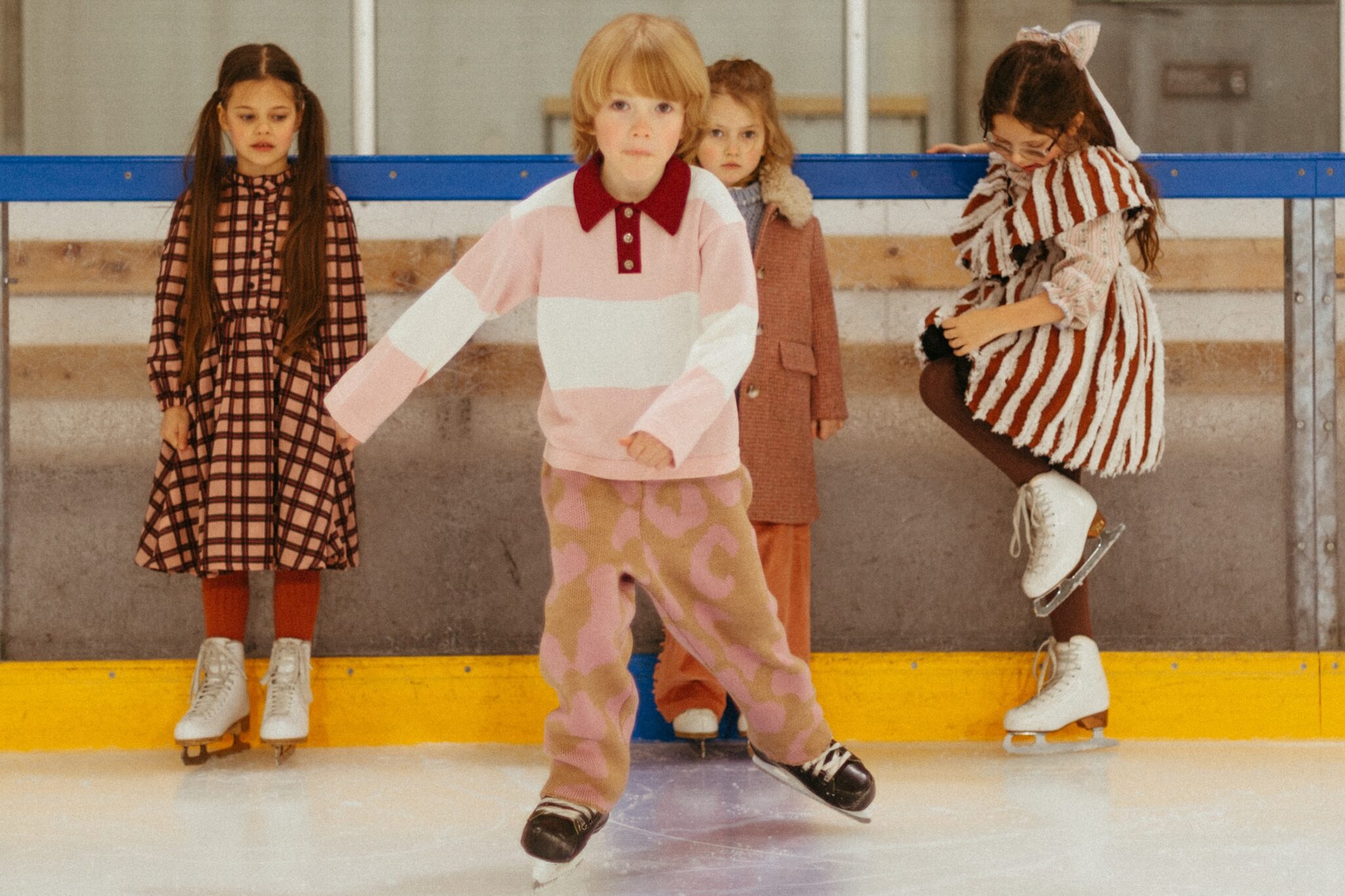 Paade Mode THE STARBOUND FW26 collection, featuring children in warm layered looks skating together at the ice rink for Scimparello Magazine.
