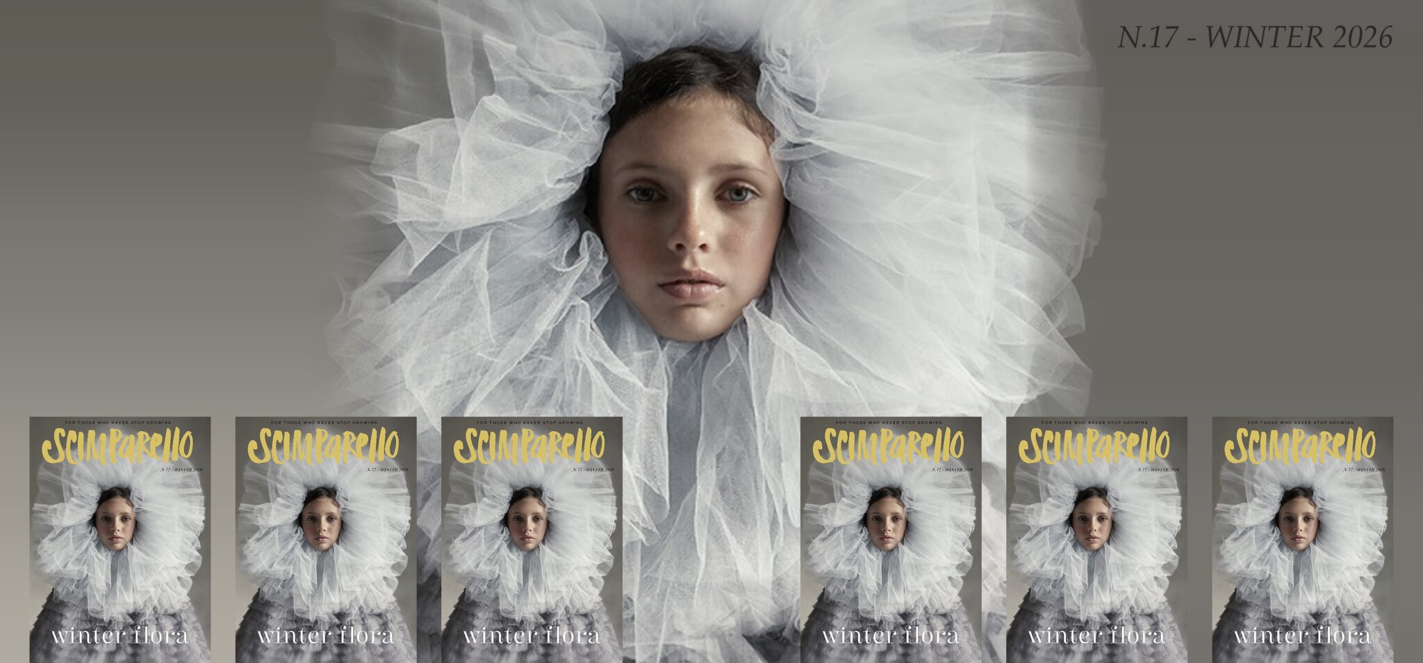 Cover of Scimparello N°17 Winter 2026, Winter Flora: a child wrapped in a huge cloud of pale grey tulle, with the yellow Scimparello logo above and 
