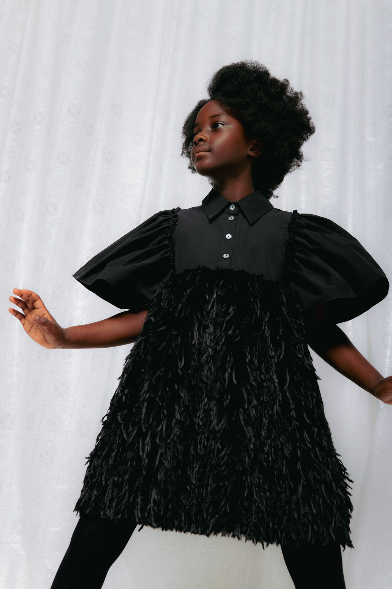 Christina Rohde AW26 black dress with voluminous puff sleeves and textured feather-like skirt