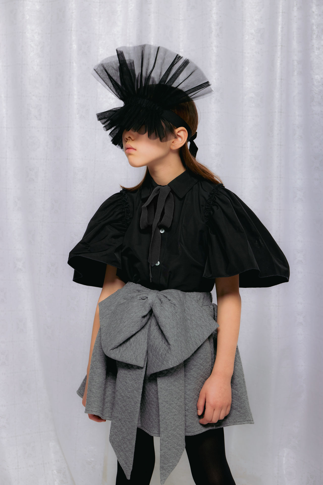 Christina Rohde AW26 black blouse with puff sleeves, oversized grey bow skirt and dramatic tulle headpiece