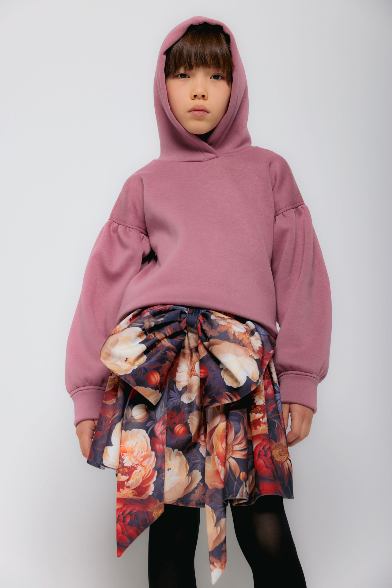 Christina Rohde AW26 mauve hoodie styled with a colourful oversized floral skirt