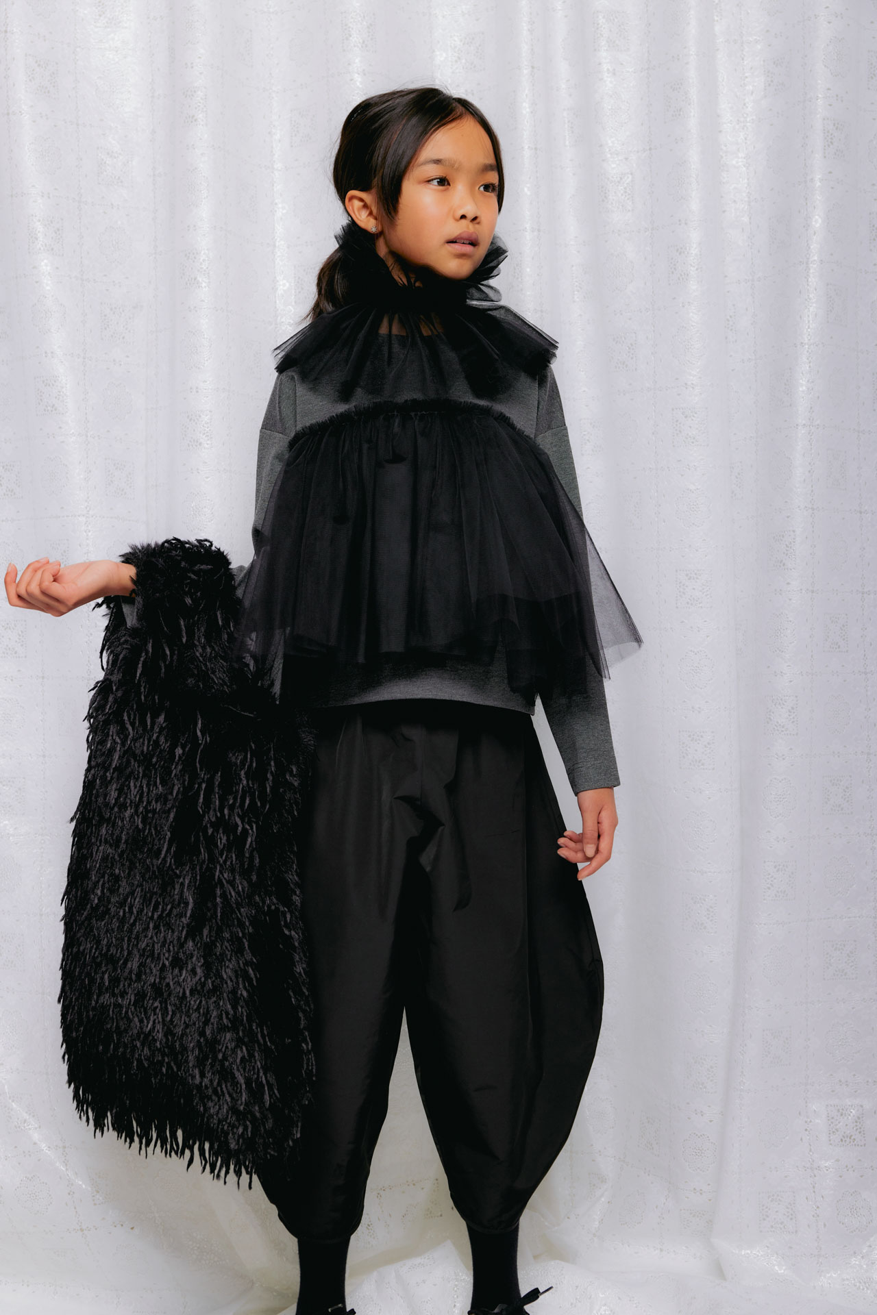 Christina Rohde AW26 layered black and grey outfit with tulle ruffles and a textured black shopper bag